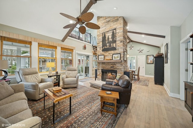 living area with baseboards, wood-type flooring, beamed ceiling, a fireplace, and high vaulted ceiling