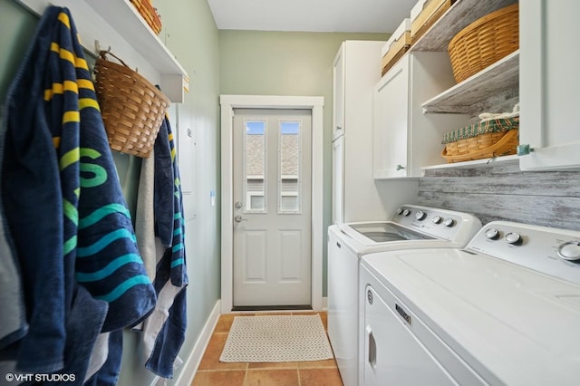 laundry area with baseboards, cabinet space, washing machine and clothes dryer, and light tile patterned flooring