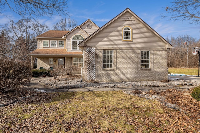 traditional-style house featuring brick siding