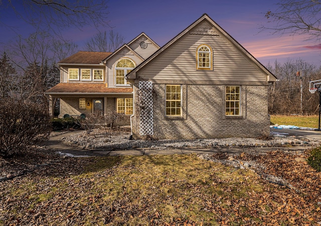 traditional-style home with brick siding