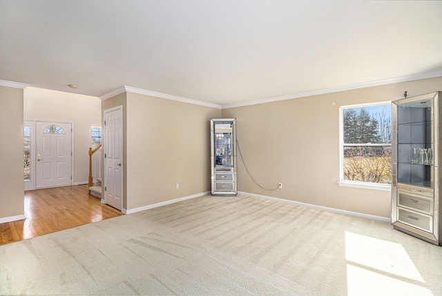 unfurnished room with stairs, ornamental molding, carpet flooring, and baseboards