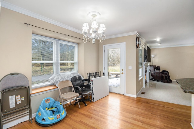 interior space with baseboards, crown molding, an inviting chandelier, and wood finished floors