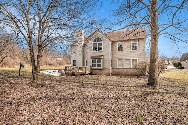 view of front of property featuring a chimney and a wooden deck