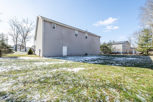 rear view of property featuring a yard