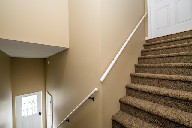 staircase with a towering ceiling