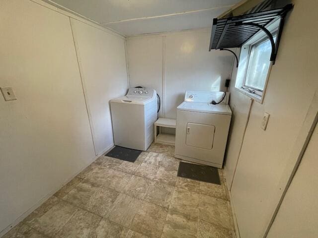 washroom with washing machine and dryer and laundry area