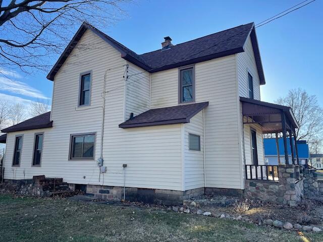 view of side of home featuring a chimney