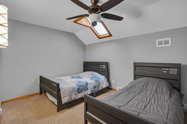 bedroom with visible vents, carpet, baseboards, ceiling fan, and lofted ceiling with skylight