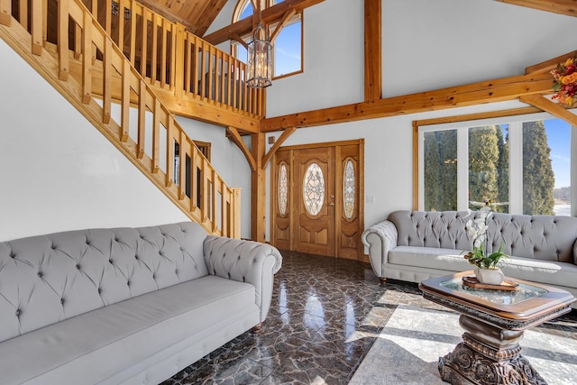 living room featuring marble finish floor, high vaulted ceiling, stairway, and a chandelier