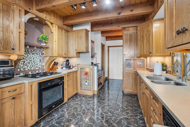 kitchen featuring light countertops, wooden ceiling, beam ceiling, a sink, and black appliances