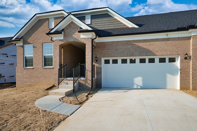 view of front of home with concrete driveway and brick siding