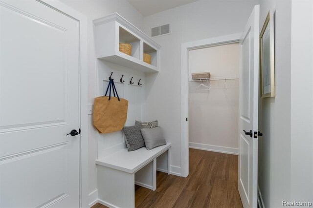 mudroom featuring baseboards, dark wood-style floors, and visible vents