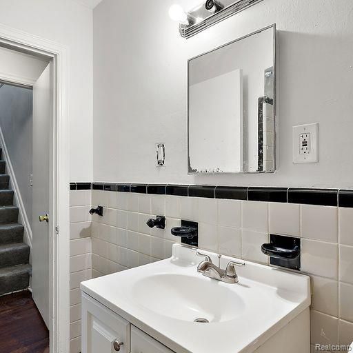 bathroom featuring tile walls and vanity