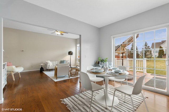 dining space featuring ceiling fan, wood finished floors, and baseboards