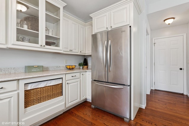 kitchen featuring dark wood-style floors, freestanding refrigerator, and white cabinets