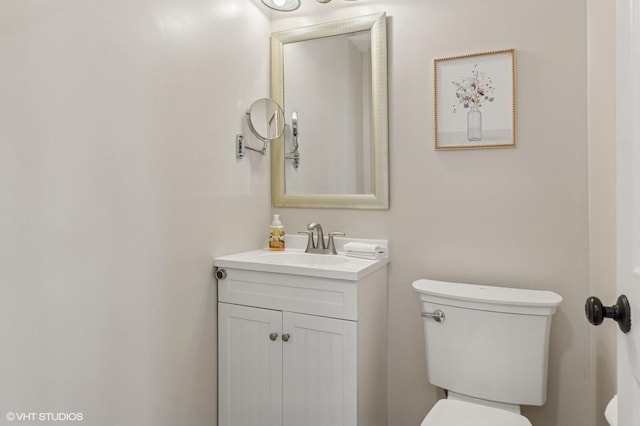 bathroom featuring toilet and vanity