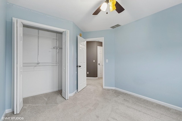 unfurnished bedroom featuring baseboards, visible vents, a ceiling fan, carpet, and a closet