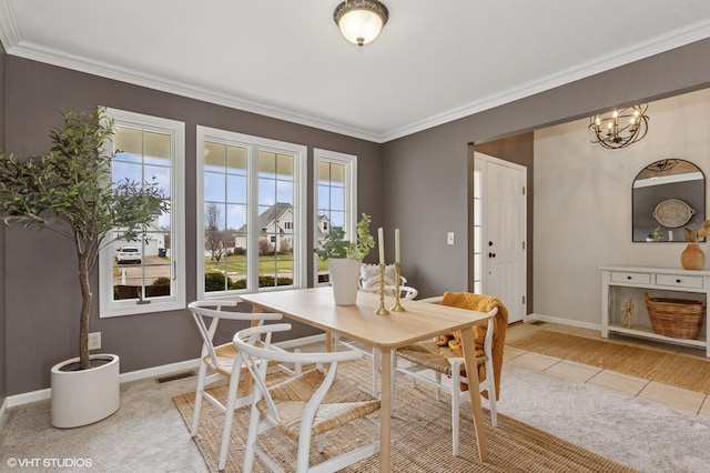 dining room featuring baseboards, light tile patterned floors, visible vents, and crown molding