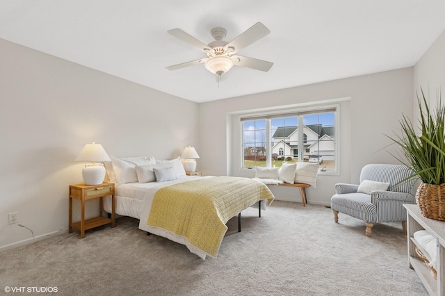 carpeted bedroom featuring a ceiling fan and baseboards