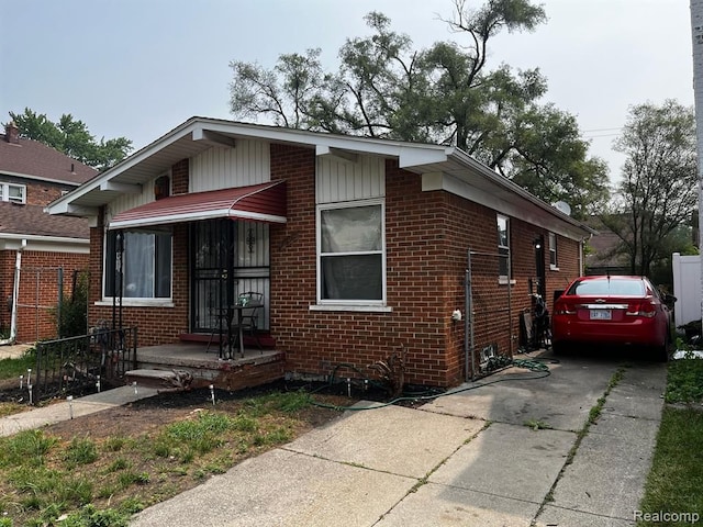 bungalow-style house with brick siding