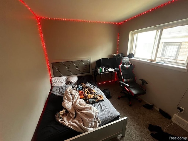 carpeted bedroom featuring baseboards