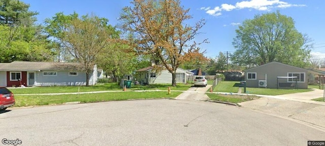 ranch-style house featuring driveway and a front lawn