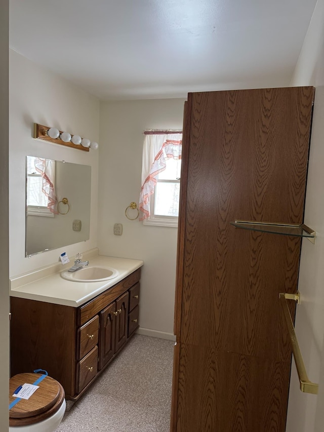 bathroom featuring baseboards and vanity