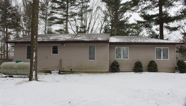 view of snow covered back of property