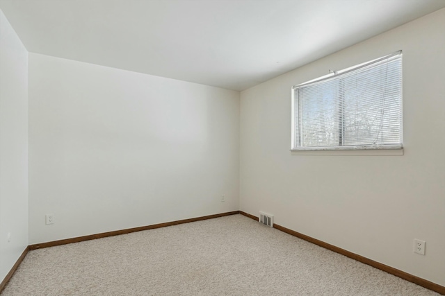 unfurnished room with baseboards, visible vents, and carpet flooring