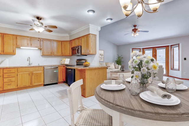 kitchen featuring appliances with stainless steel finishes, light countertops, light tile patterned flooring, and ceiling fan with notable chandelier