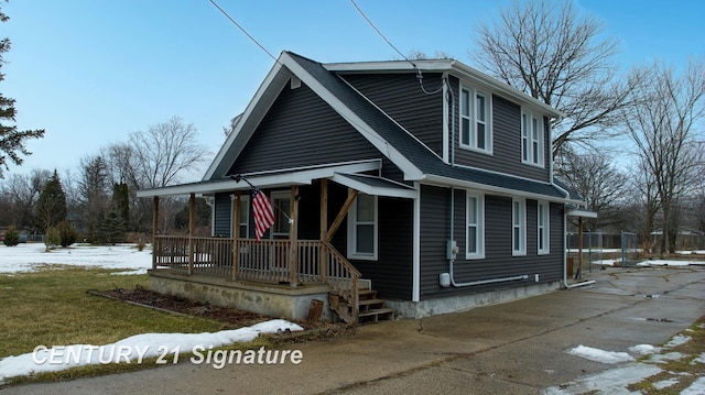 view of front of property with covered porch and roof with shingles