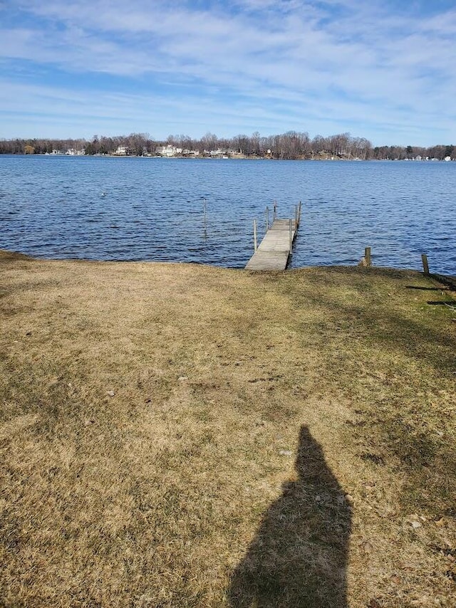 dock area featuring a lawn and a water view