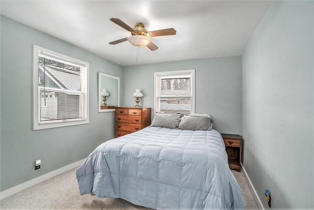 bedroom with ceiling fan, carpet floors, and baseboards