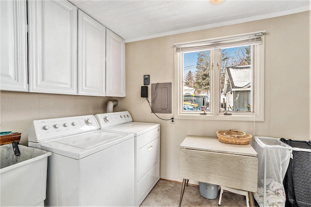 clothes washing area featuring ornamental molding, cabinet space, independent washer and dryer, and a sink