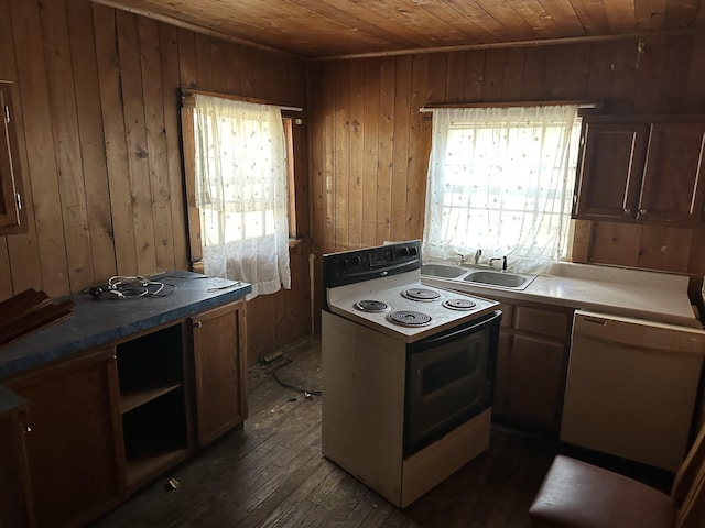 kitchen with white appliances, wooden walls, wooden ceiling, dark wood-type flooring, and a sink