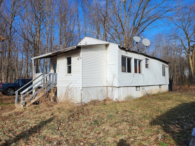 view of property exterior featuring a lawn