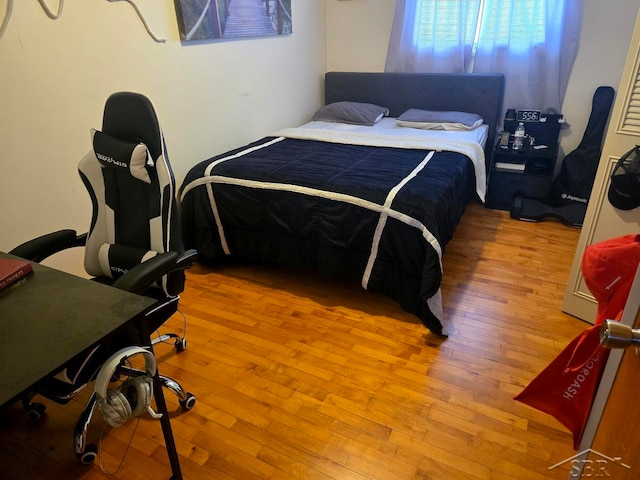 bedroom with hardwood / wood-style floors