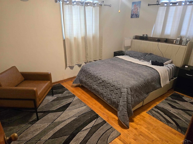 bedroom featuring light wood-style flooring and baseboards