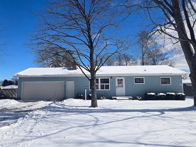 view of front of home featuring a garage and fence