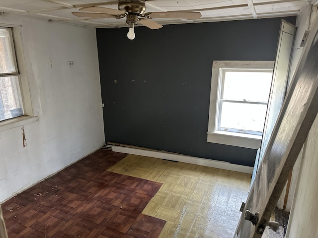 empty room featuring ceiling fan and tile patterned floors