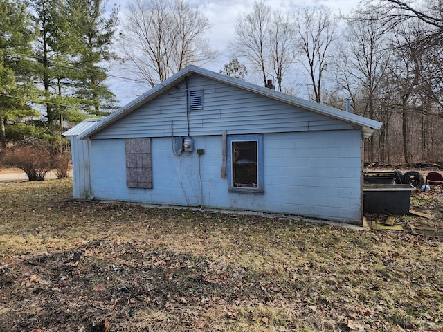 view of side of home with concrete block siding