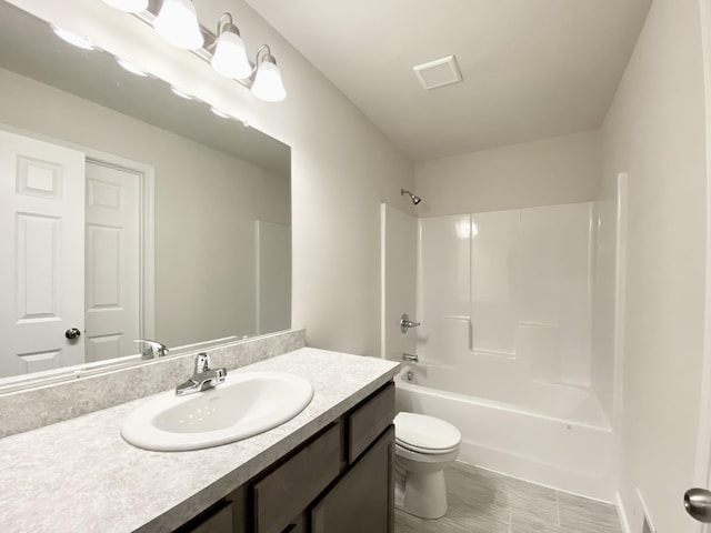 full bathroom featuring visible vents, vanity, toilet, and tub / shower combination