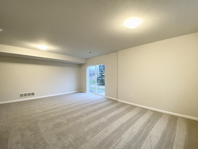 carpeted empty room with baseboards and visible vents