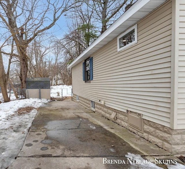 view of snowy exterior featuring an outbuilding