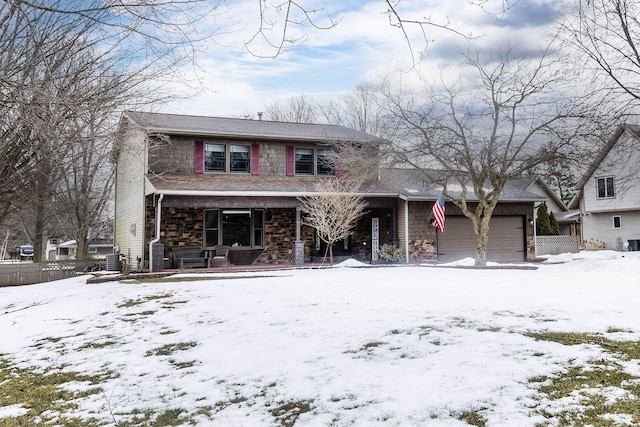 traditional home featuring a garage, stone siding, and a porch