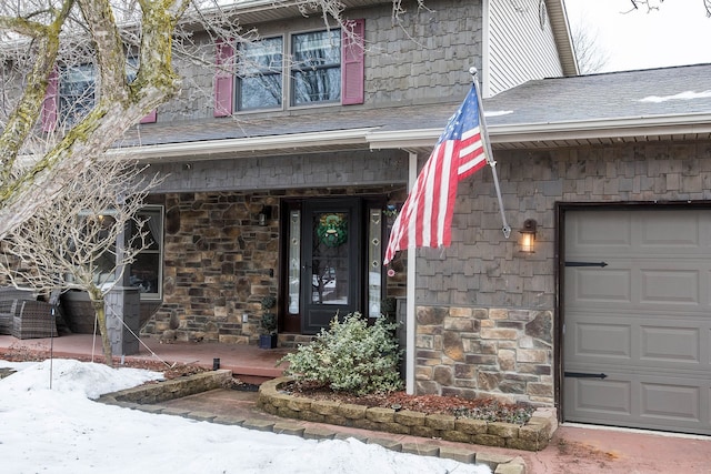 doorway to property featuring a shingled roof, stone siding, and a porch