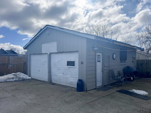 detached garage featuring fence