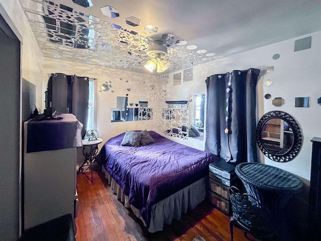 bedroom featuring visible vents and hardwood / wood-style floors