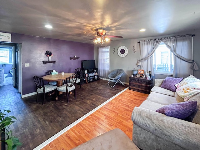 living area featuring recessed lighting, wood finished floors, and baseboards