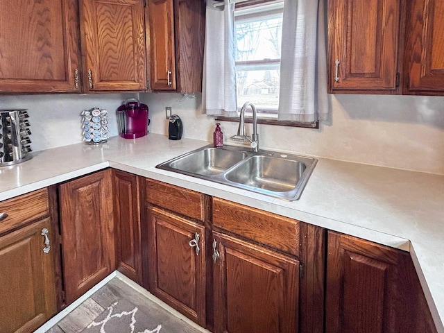 kitchen featuring light countertops and a sink